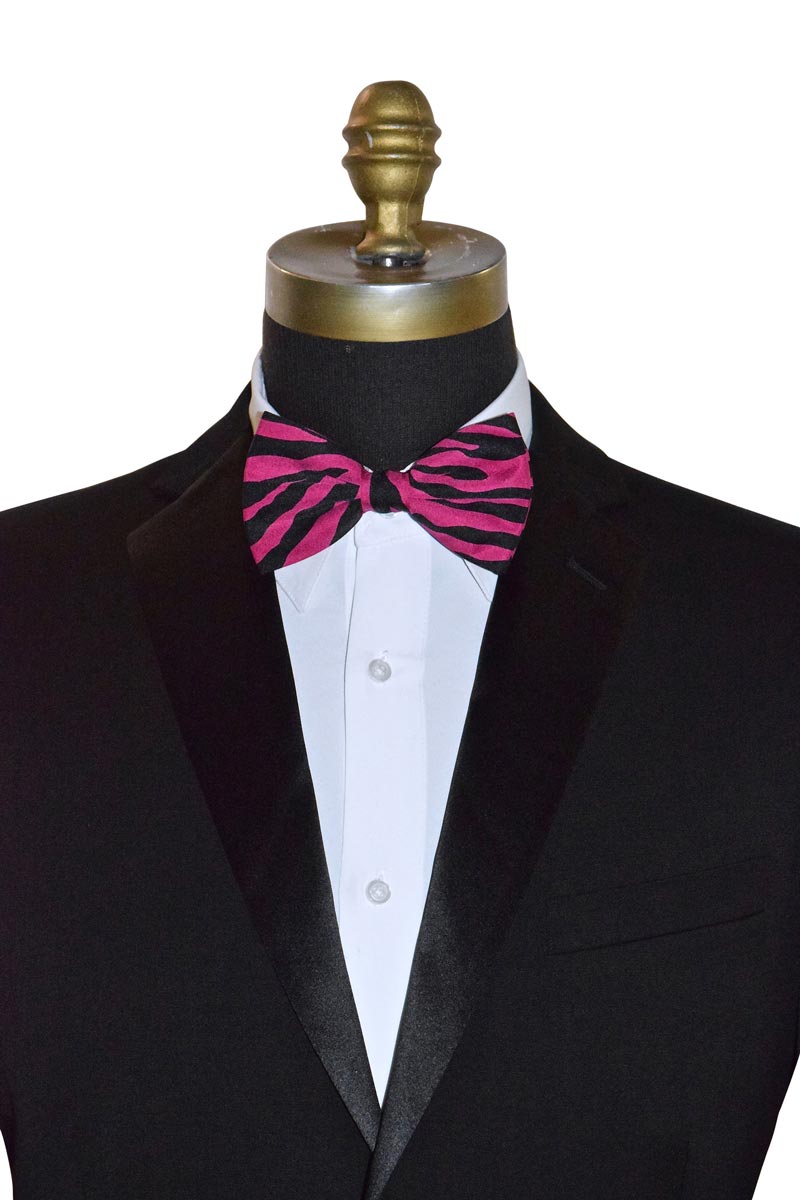 Mannequin wearing a black tuxedo with a white shirt and magenta and black zebra striped bow tie.