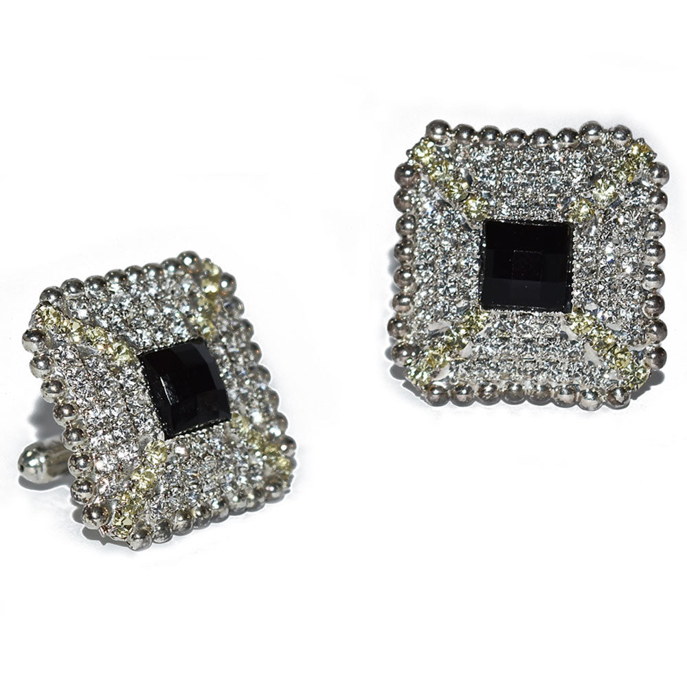 Pair of bling square cufflinks with black center and diamond-like stones on a white background