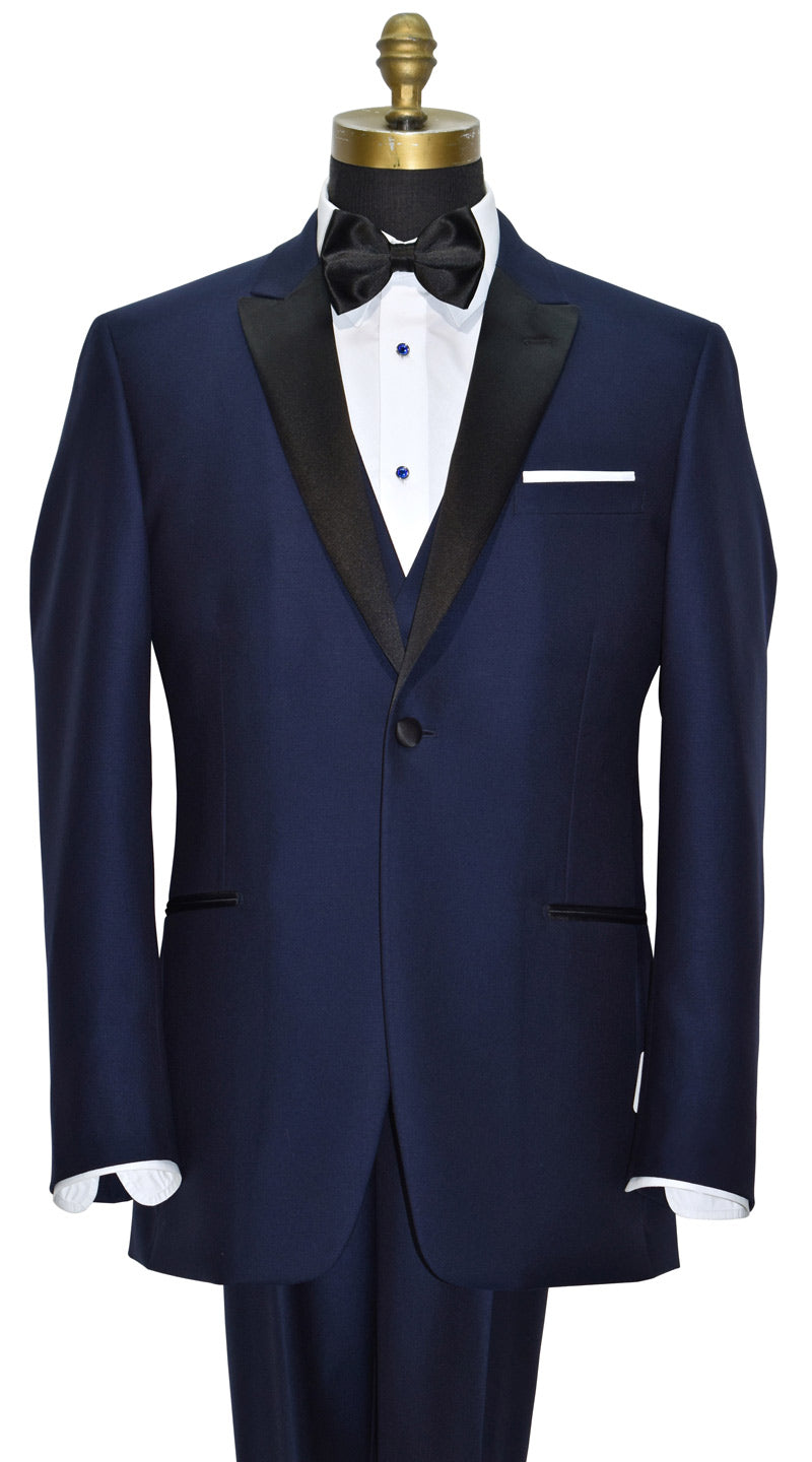 Navy blue tuxedo with black lapels wearing a navy blue tuxedo vest on a mannequin against a white background