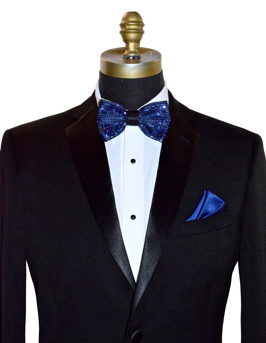 Black tuxedo with a royal blue sequin bow tie and pocket square on a mannequin against a white background