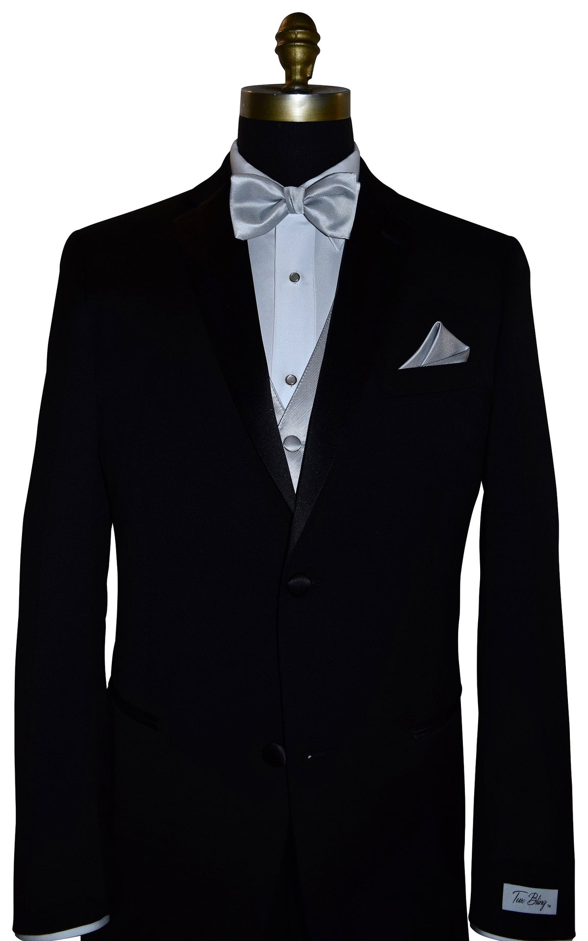 Black tuxedo with white shirt, silver vest and bow tie, and pocket square on a mannequin.