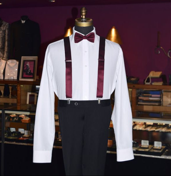 mannequin wearing a white tuxedo shirt with wine suspenders and a wine bowtie inside a tuxedo shop