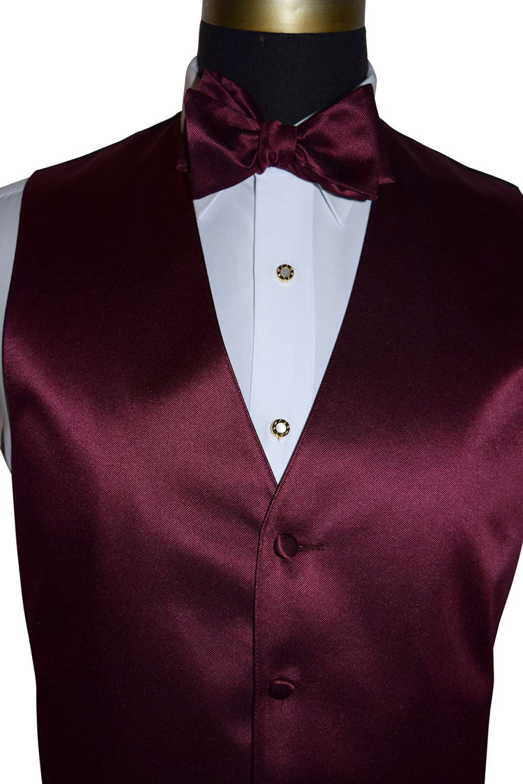 close-up front view Wine colored vest and bow tie set on a mannequin with a white shirt against a white bq\ackground