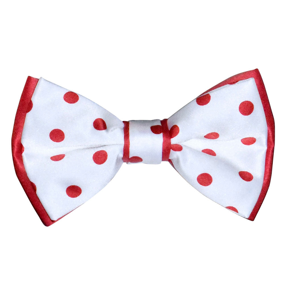 White bow tie with red polka dots on a white background