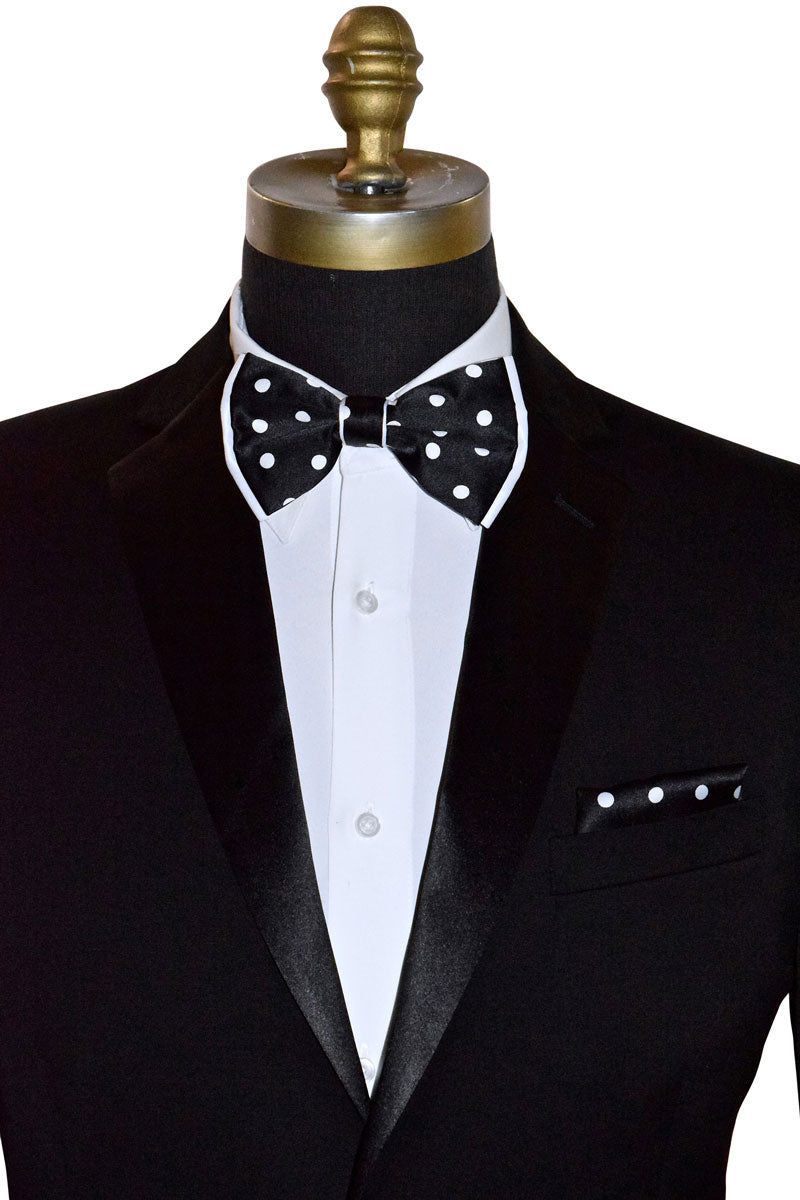 Black tuxedo with a white dress shirt and black bow tie with white polka-dots on a mannequin against a white background