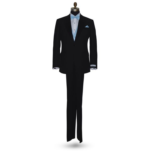 full mannequin front view Black tuxedo with "San Miguel Especial" branded label wearing a capri-blue bow tie and pocket square against a white background