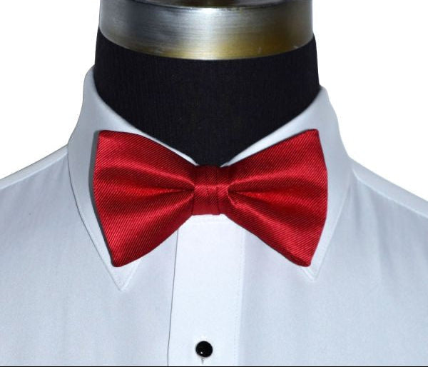 very close mannequin wearing a white tuxedo shirt with a red pre-tied bowtie