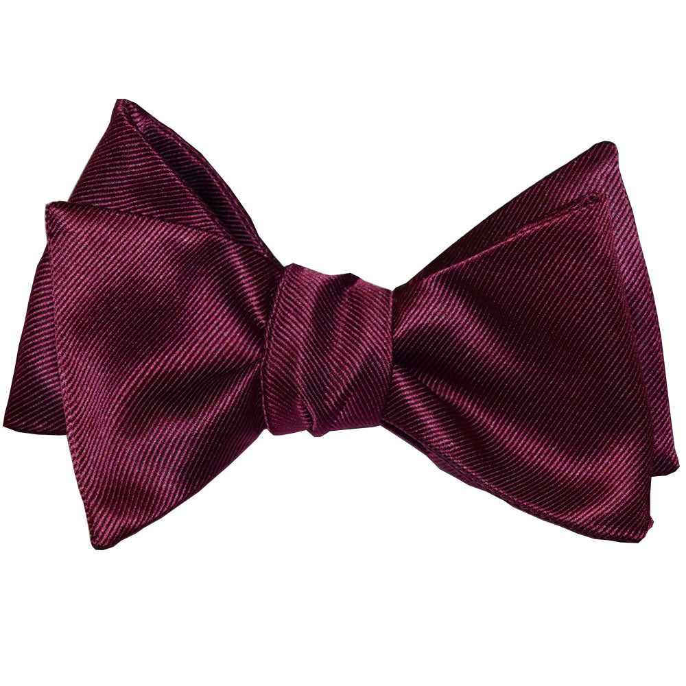 Wine colored "tie-yourself" bow tie on a white background