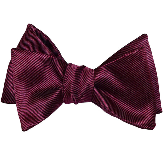 Wine colored "tie-yourself" bow tie on a white background