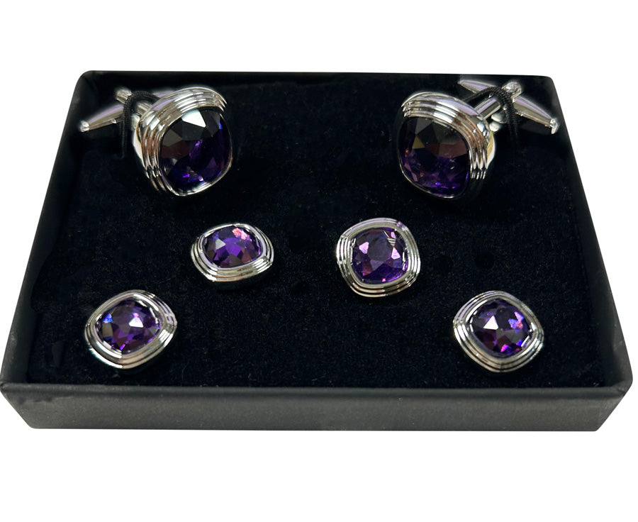 Set of purple gemstone cufflinks and studs with silver setting in a black display box.