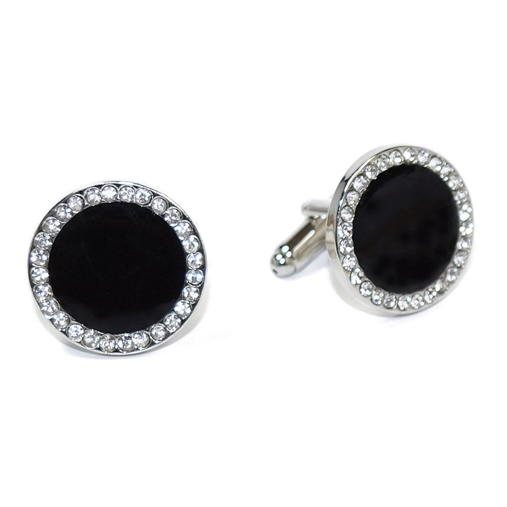 Black cufflinks with silver circular designs with cubic zirconia crystals on a white background