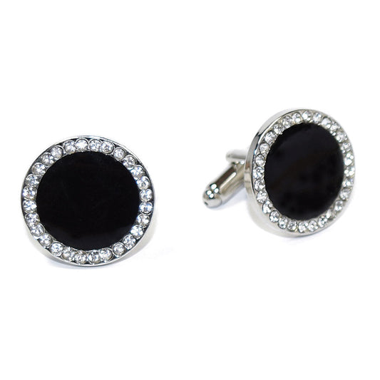 Black cufflinks with silver circular designs with cubic zirconia crystals on a white background