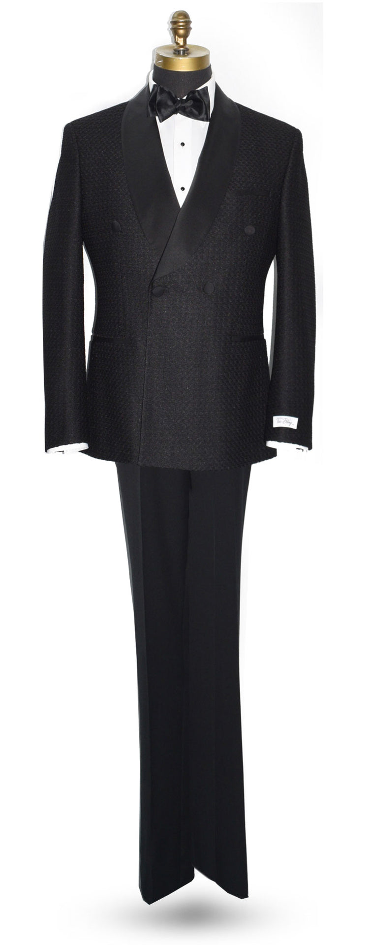 life size mannequin wearing a black double-breasted shawl collar tuxedo with a black bow tie against a white background 