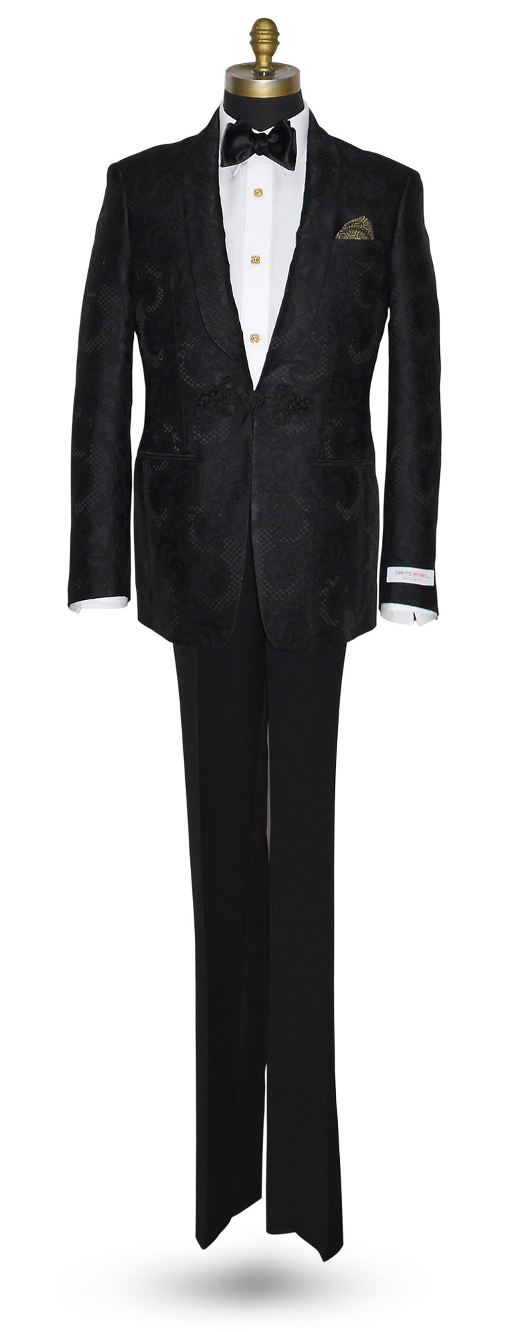 mannequin wearing Black shawl collar tuxedo with brocade pattern shown with white tuxedo shirt and black bow tie on a white background