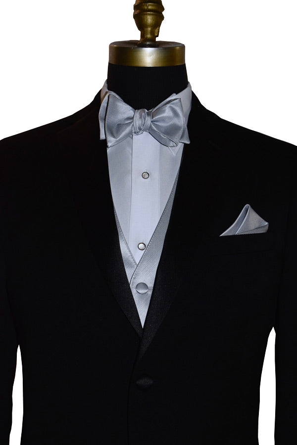 close-up Black tuxedo with silver "self-tie" bow tie and pocket square on a mannequin against a white background