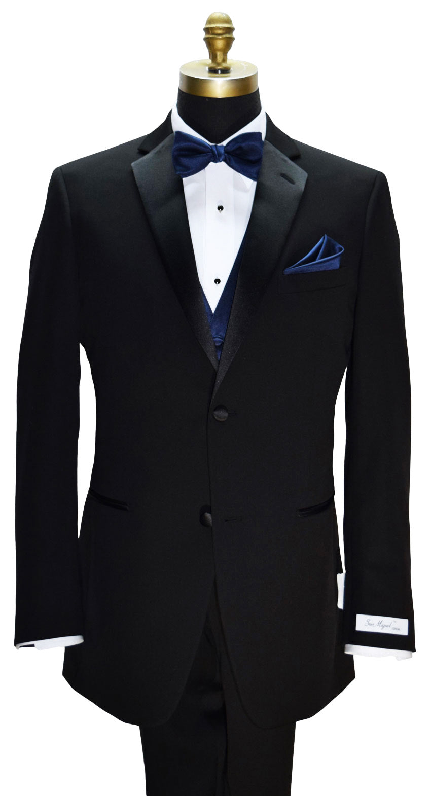 Black tuxedo with a marine blue bow tie and pocket square on a mannequin with a "San Miguel Especial" branded label  against a white background