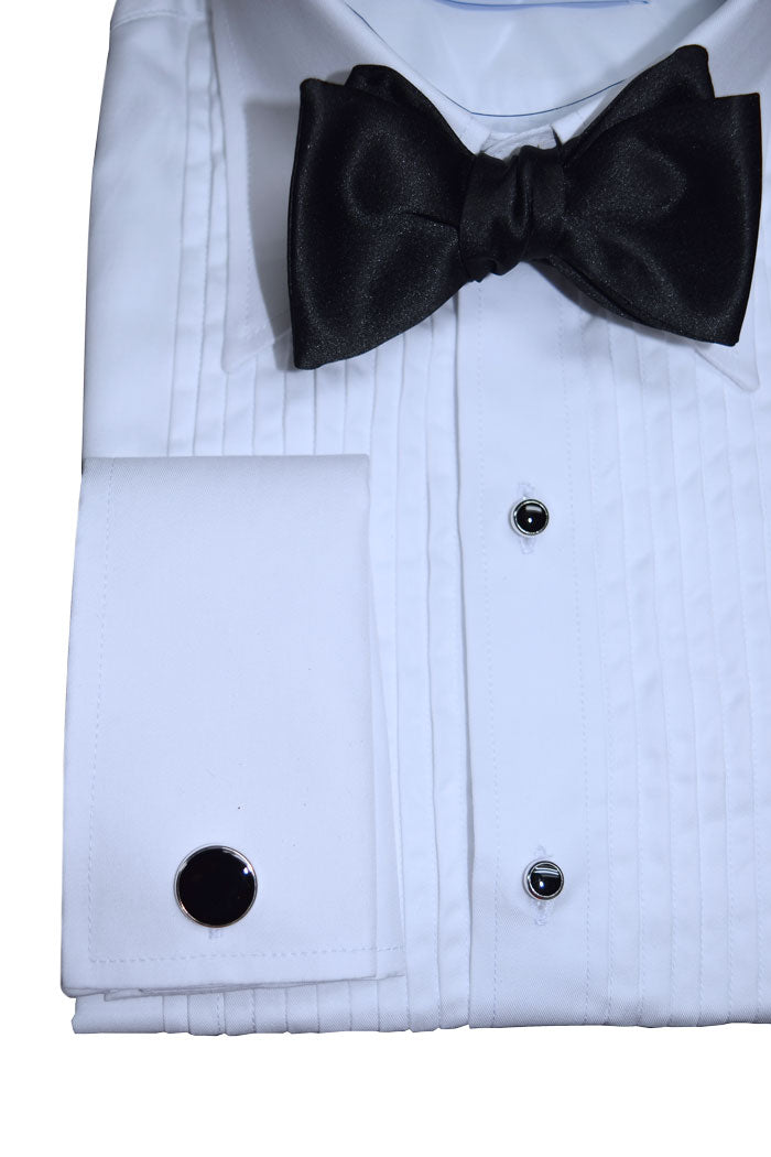 White tuxedo shirt with black bow tie and silver and black studs and cufflinks on a white background