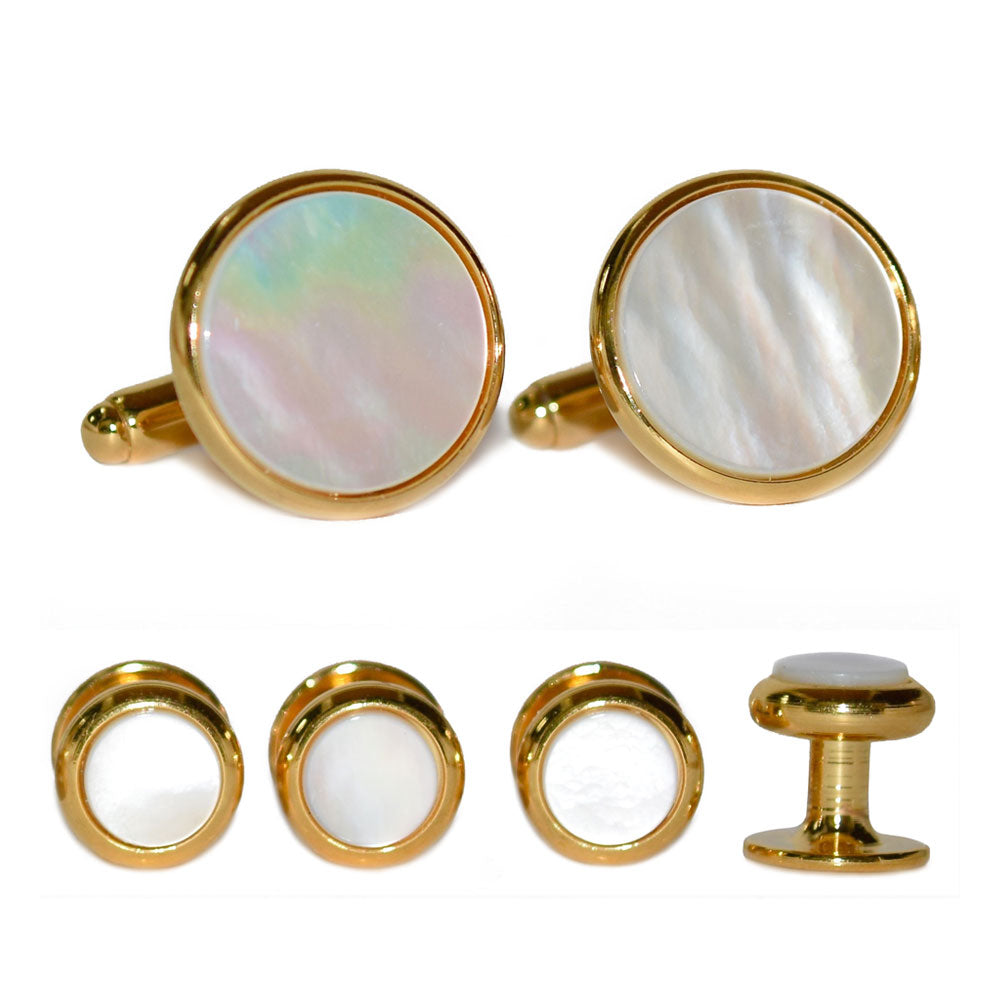 close-up pearl cufflinks and studs with gold setting against a white background