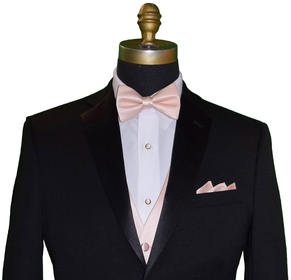close-up Black tuxedo with "pre-tied" petal color bow tie and pocket square on a mannequin against a white background