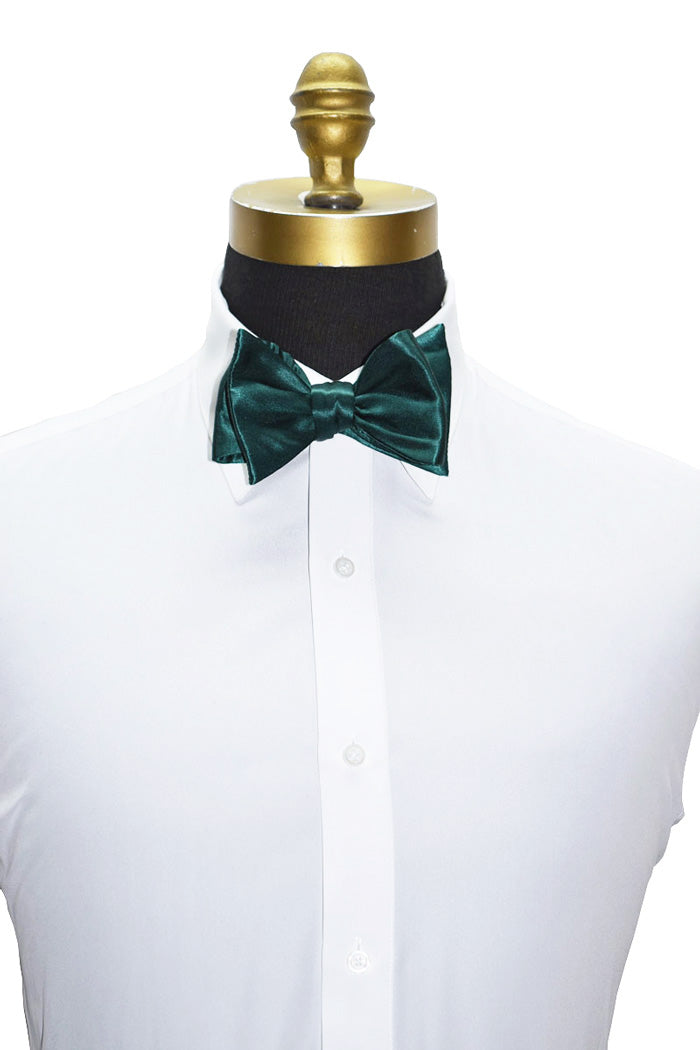 hunter Green silk "tie-yourself" bow tie on a white shirt with a gold mannequin head.