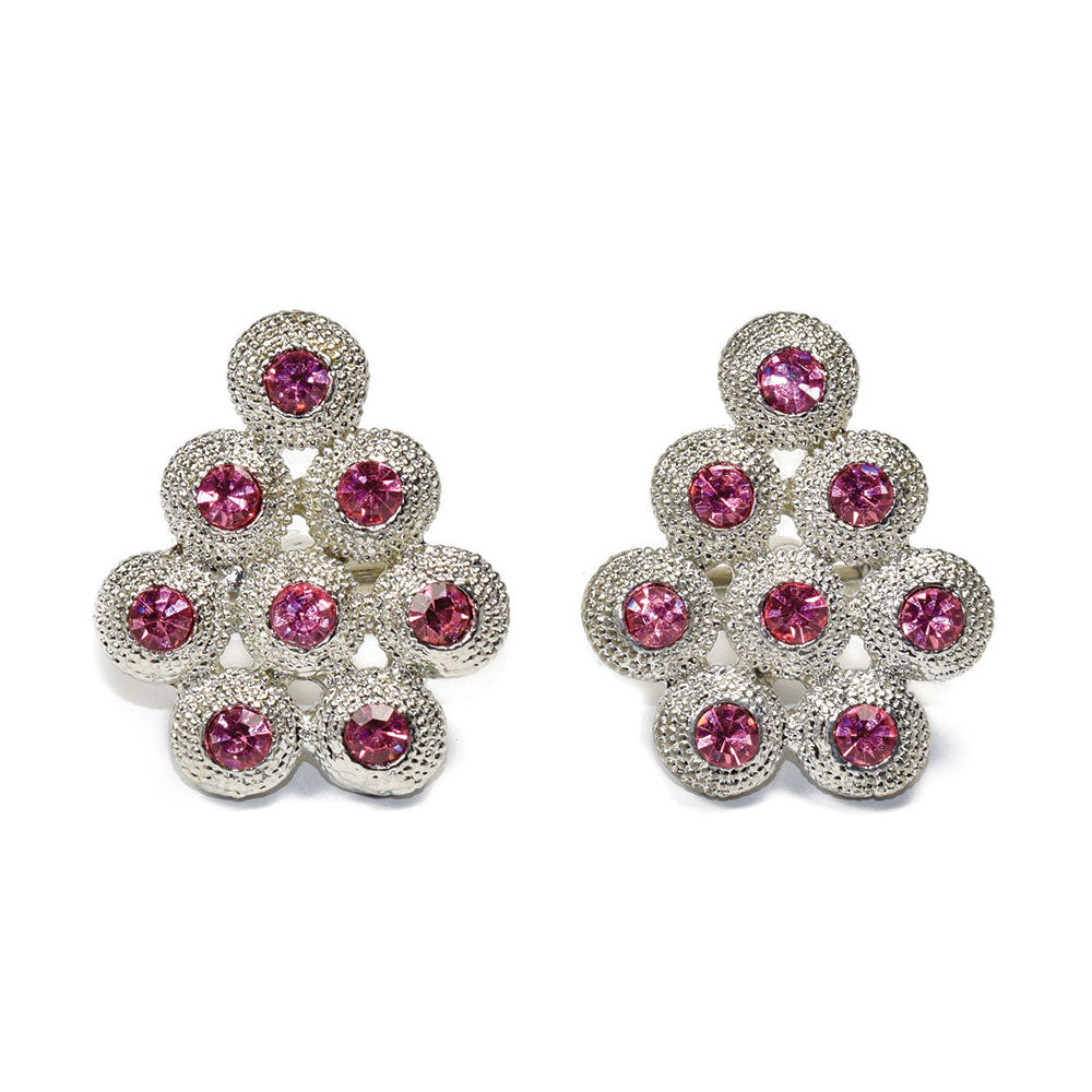 Pair of cufflinks with pink gemstones on a white background
