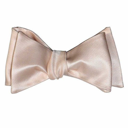 Nude color "tie-yourself" bow tie on a white background