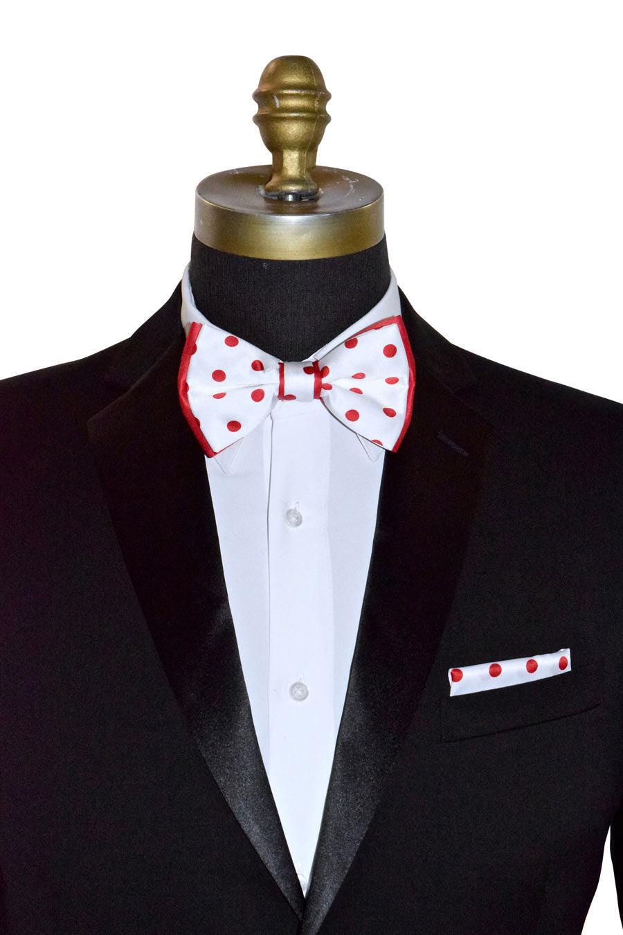 Black tuxedo with a red and white polka dot bow tie and matching handkerchief on a mannequin.