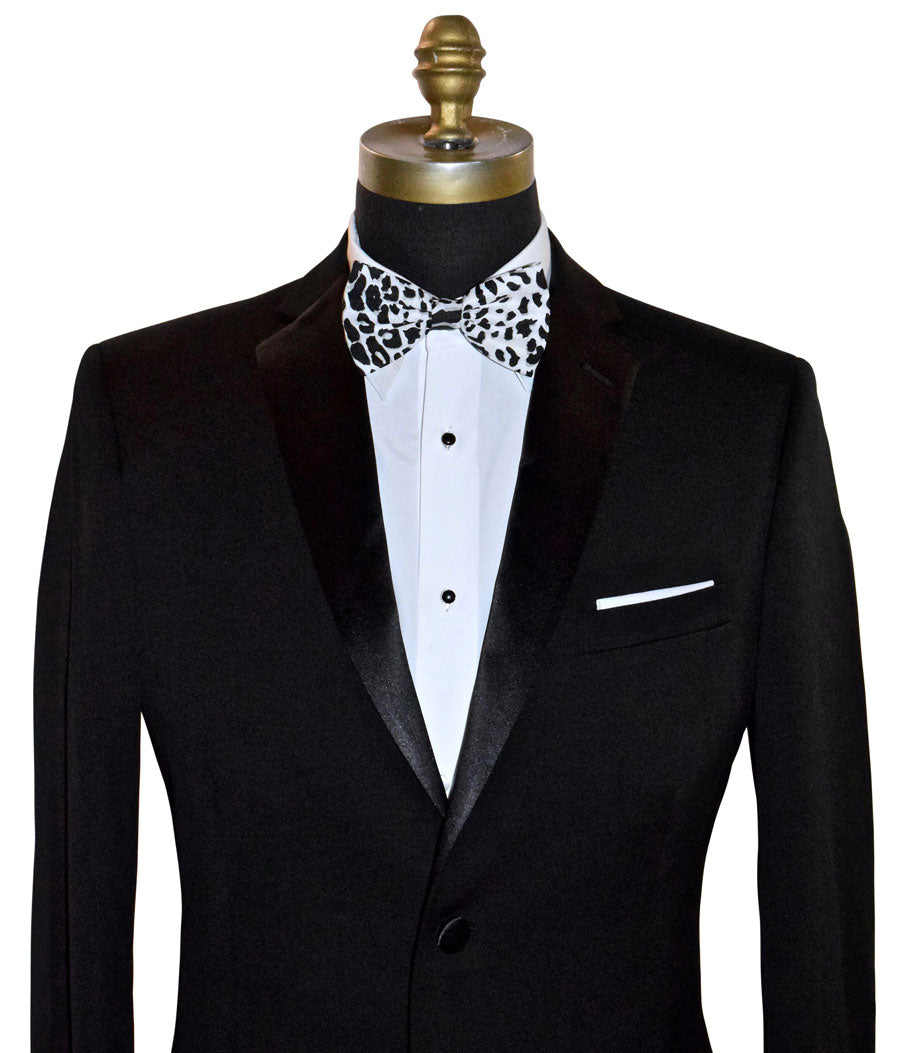 Black tuxedo with a white dress shirt and black and white leopard print bow tie on a mannequin.