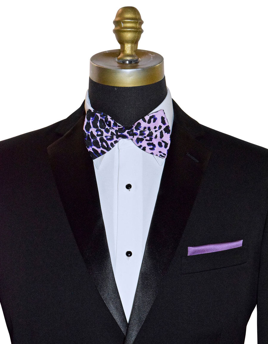 Black tuxedo with a white shirt, purple and pink leopard print bow tie, and matching pocket square on a mannequin