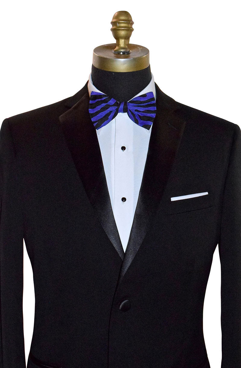 Black tuxedo with a white shirt and purple and black zebra print bow tie on a mannequin against a white background.