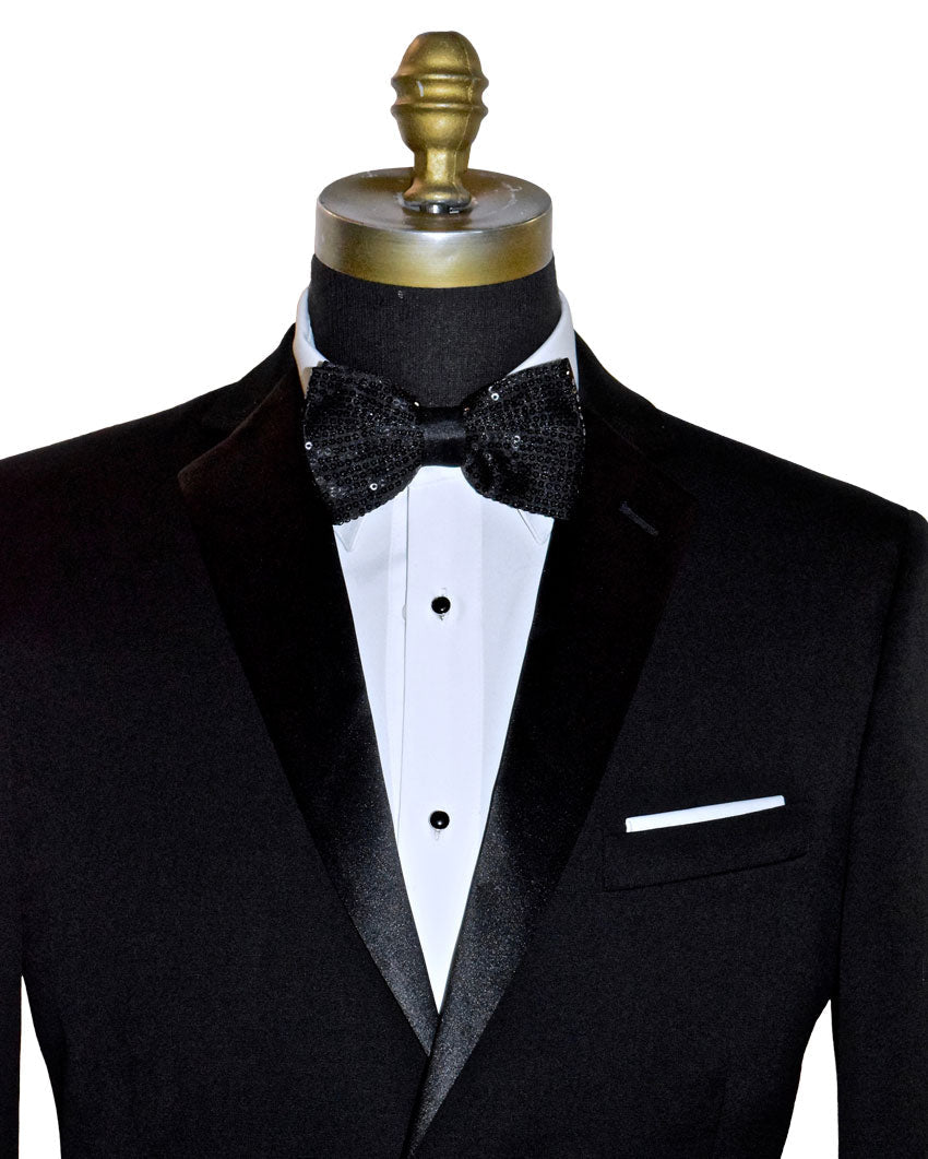 Black tuxedo with a black sequin bow tie on a mannequin against a white background