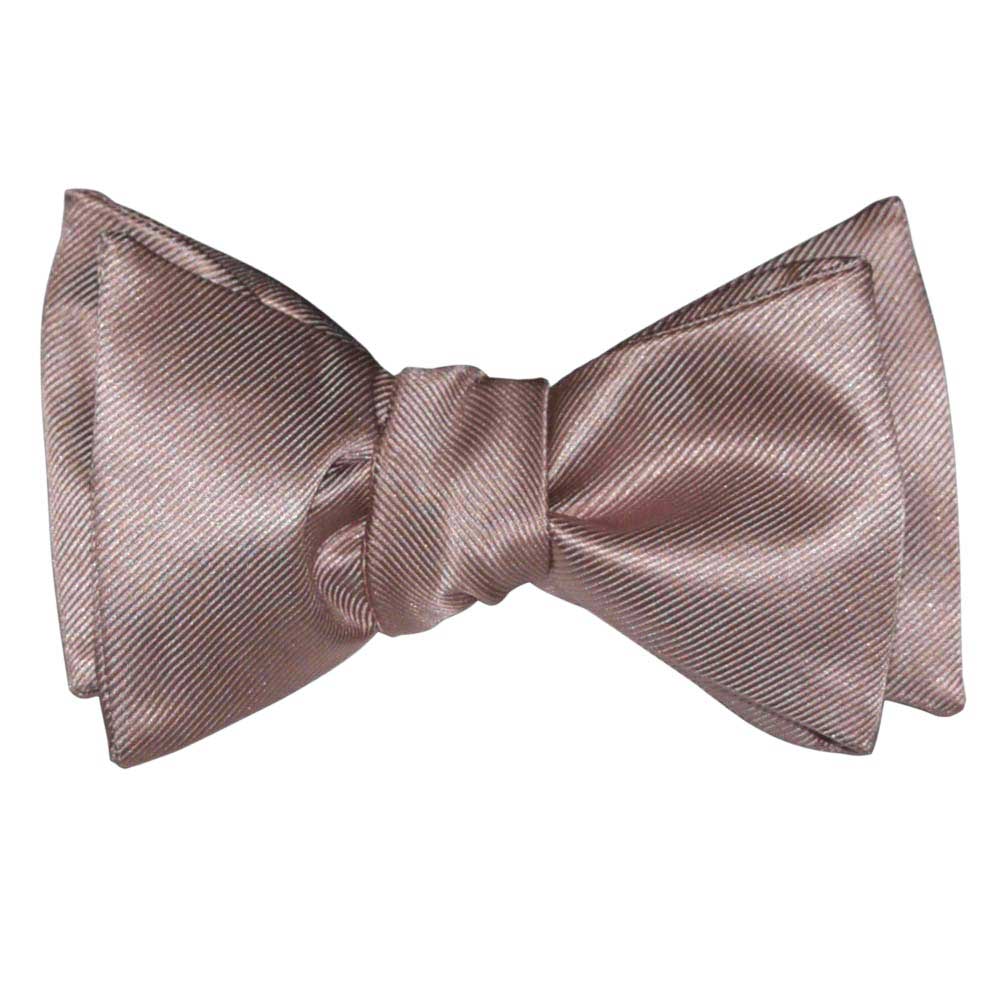 Rose-gold color "tie-yourself" bow tie on a white background