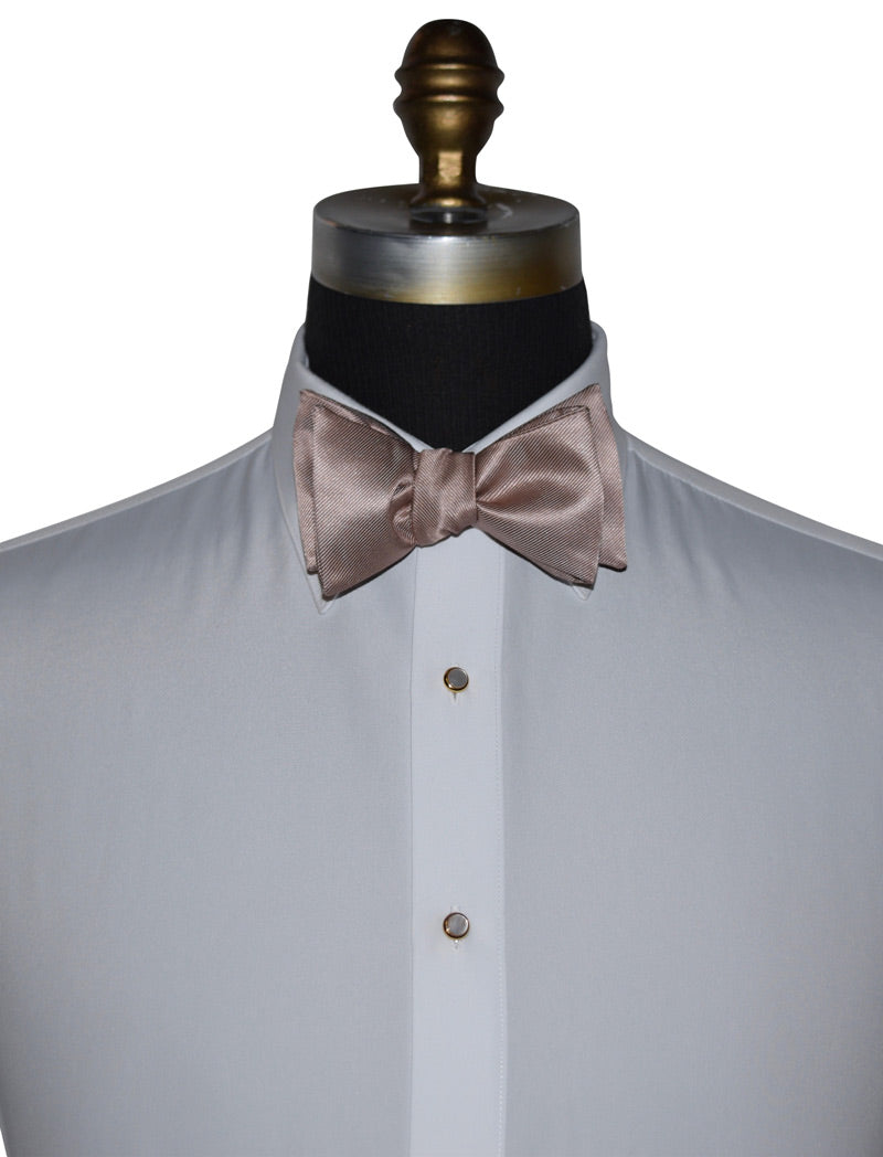 mannequin wearing a white tuxedo shirt with a rose-gold tie-yourself bowtie against a white background