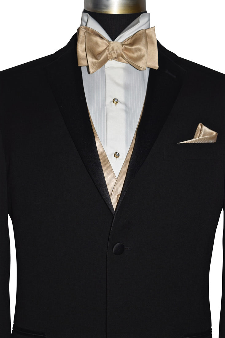 close up front view golden "tie-yourself" bowtie shown on mannequin with a black tuxedo against a white background