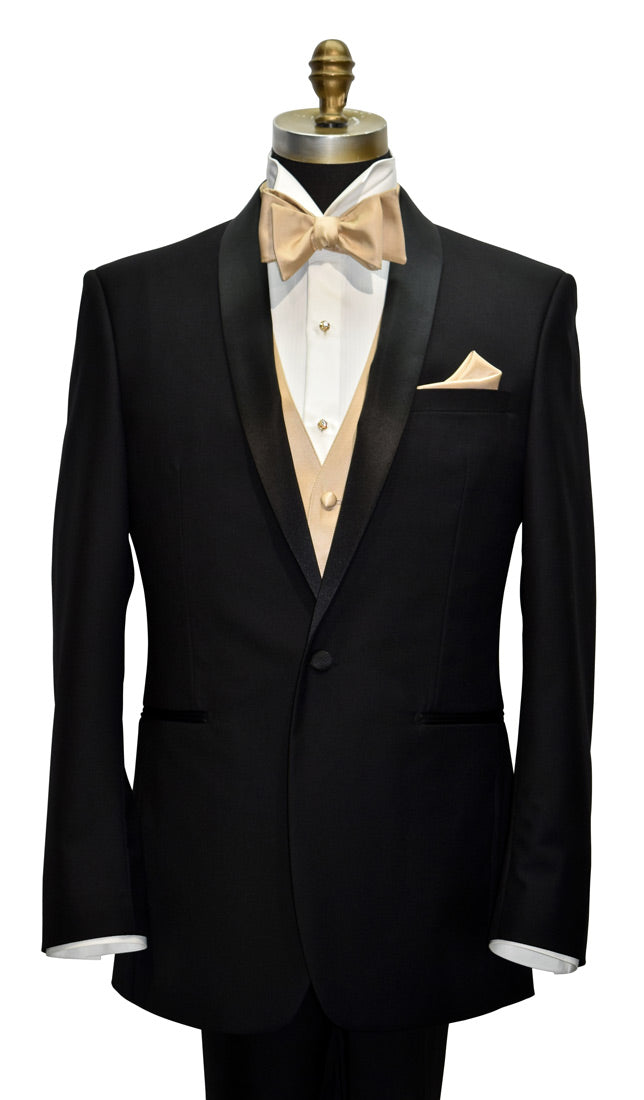 Black shawl collar tuxedo with gold "tie-yourself" bow tie and pocket square on a mannequin against a white background