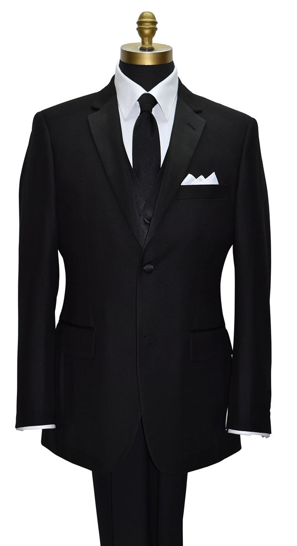 close-up black notch lapel tuxedo with a white tuxedo shirt and a long black necktie and a four-button black tuxedo vest against a white background