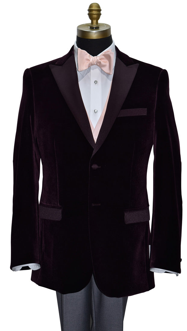Burgundy tuxedo with blush "tie-yourself" bow tie, matching vest and pocket square on a mannequin against a white background