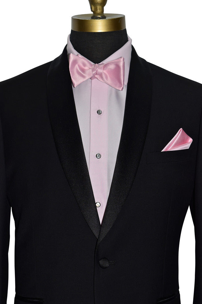 mannequin wearing a Black tuxedo with pink tuxedo shirt and pink bow tie with mother-of-pearl-studs and cufflinks against a white background