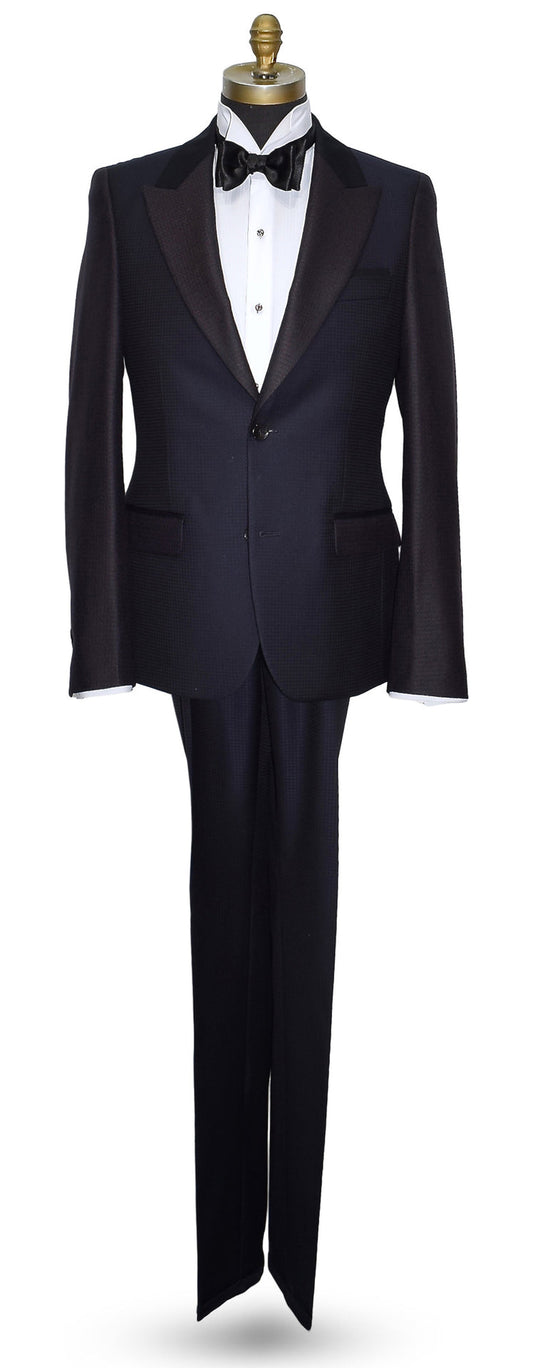 life size mannequin wearing a navy blue peak lapel tuxedo on a mannequin against a white background