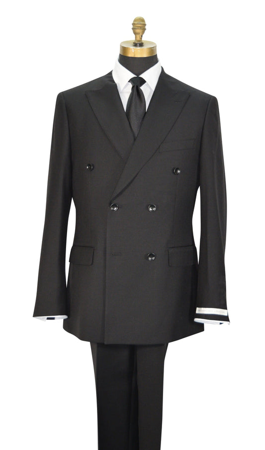 A black double-breasted men's suit displayed on a mannequin torso with a white dress shirt, black necktie, and black trousers. The jacket features peak lapels, six buttons, flap pockets, and super lightweight tropical wool.