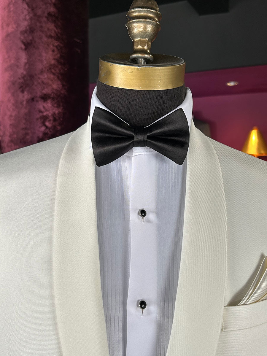 Off-white tuxedo with a black bow tie on a mannequin against a dark background.