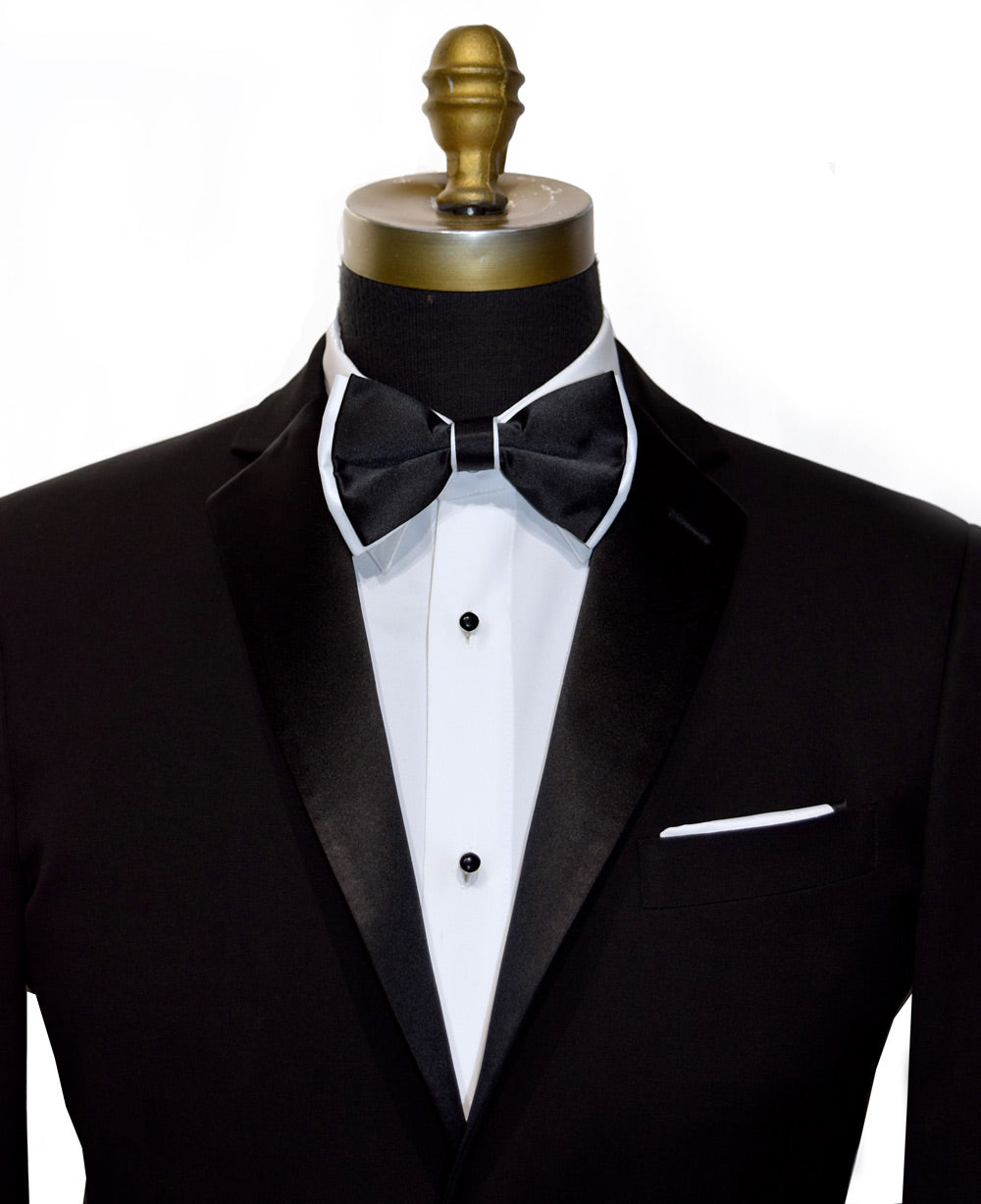 Black tuxedo with white shirt and black bow tie with white trim  on mannequin against a white background