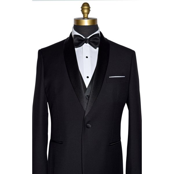 close-up front view mannequin wearing a black tuxedo with a white tuxedo shirt and black bowtie with slight texture on a white background