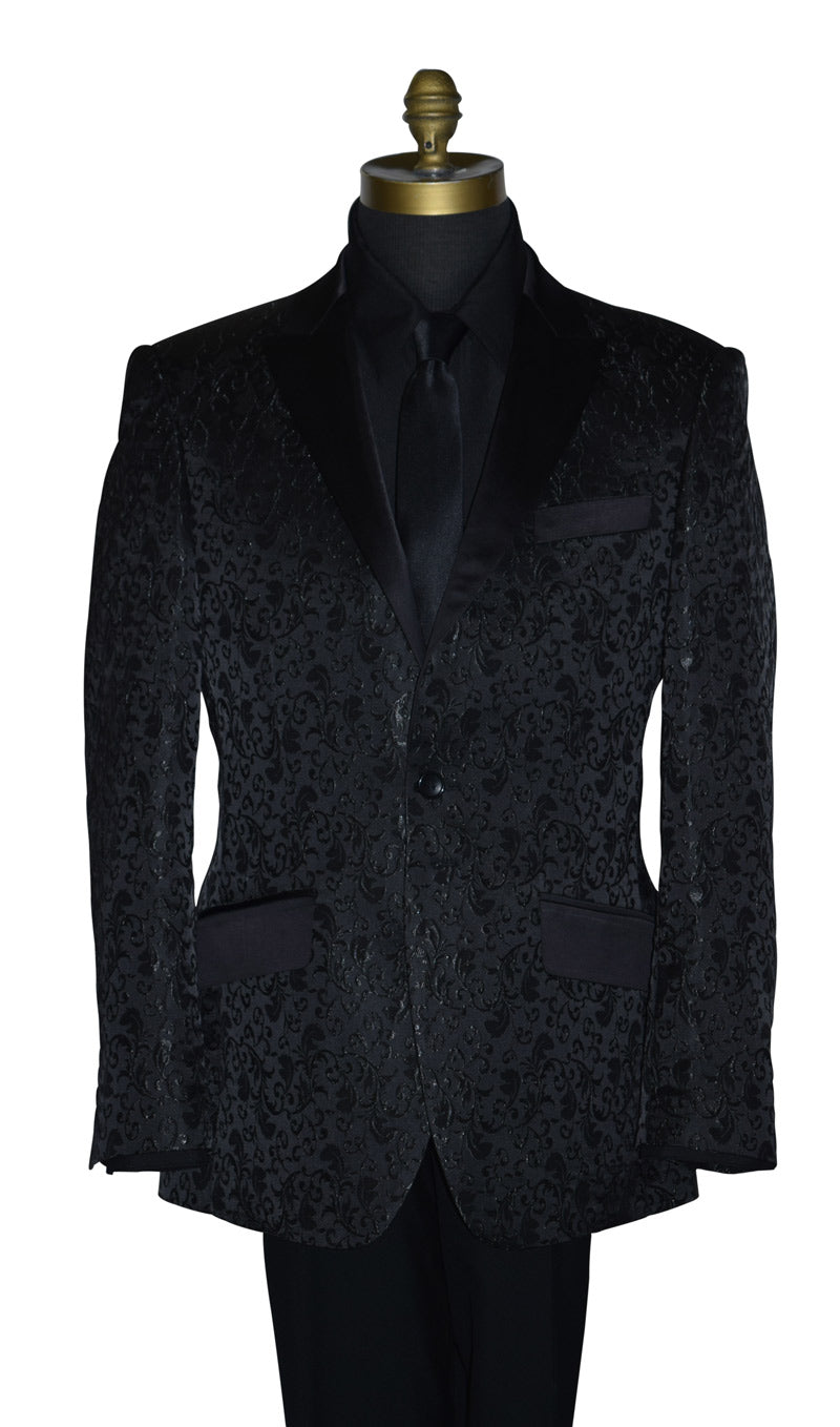 close-up Black brocade tuxedo wearing a black shirt and long black necktie on a mannequin against a white background