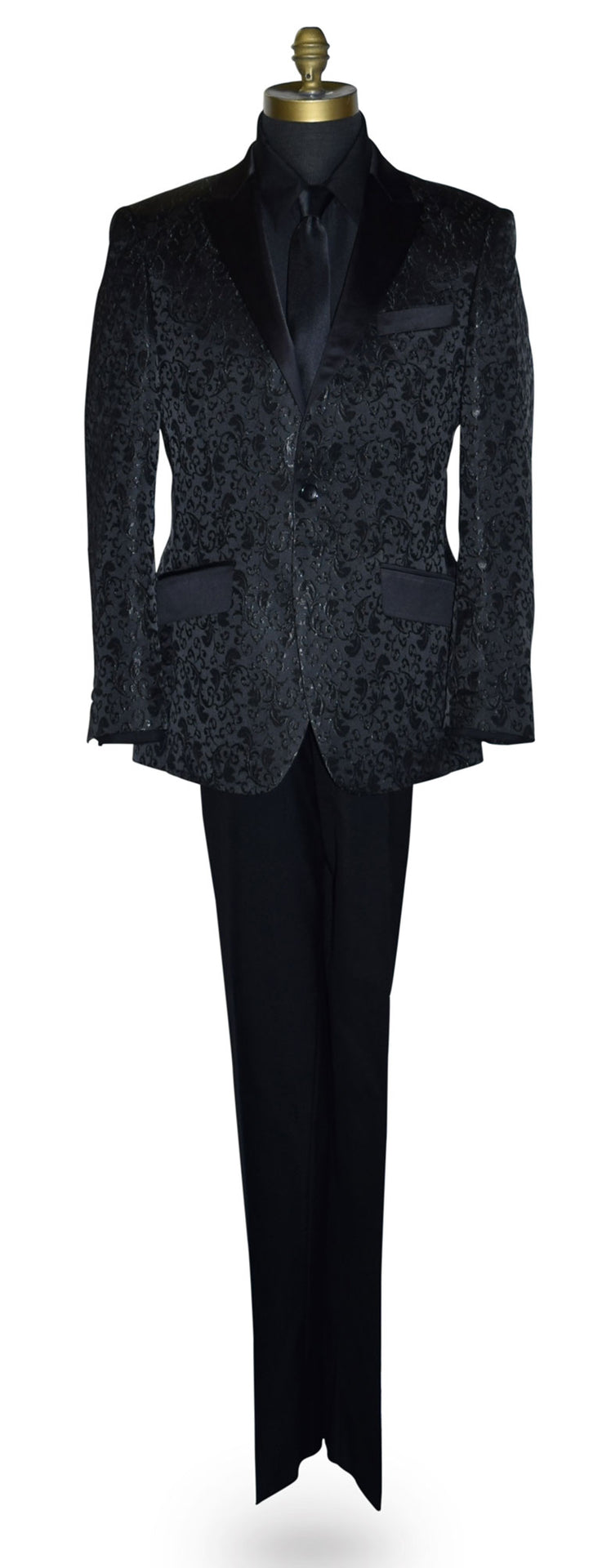 Black brocade tuxedo wearing a black shirt and long black necktie on a mannequin against a white background