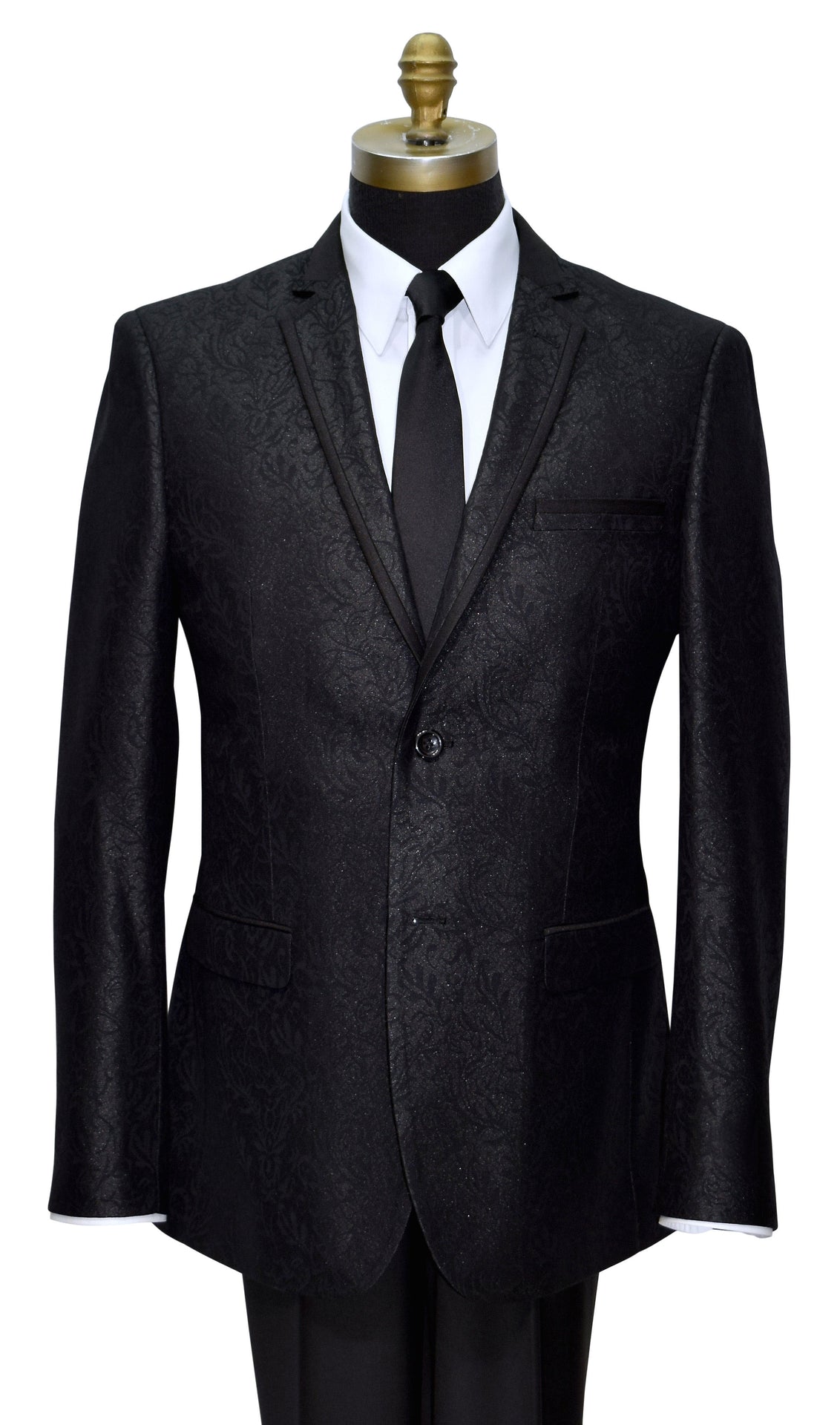 Black brocade notch lapel tuxedo with satin trim on the lapel on a mannequin with a white shirt and black tie against a white background