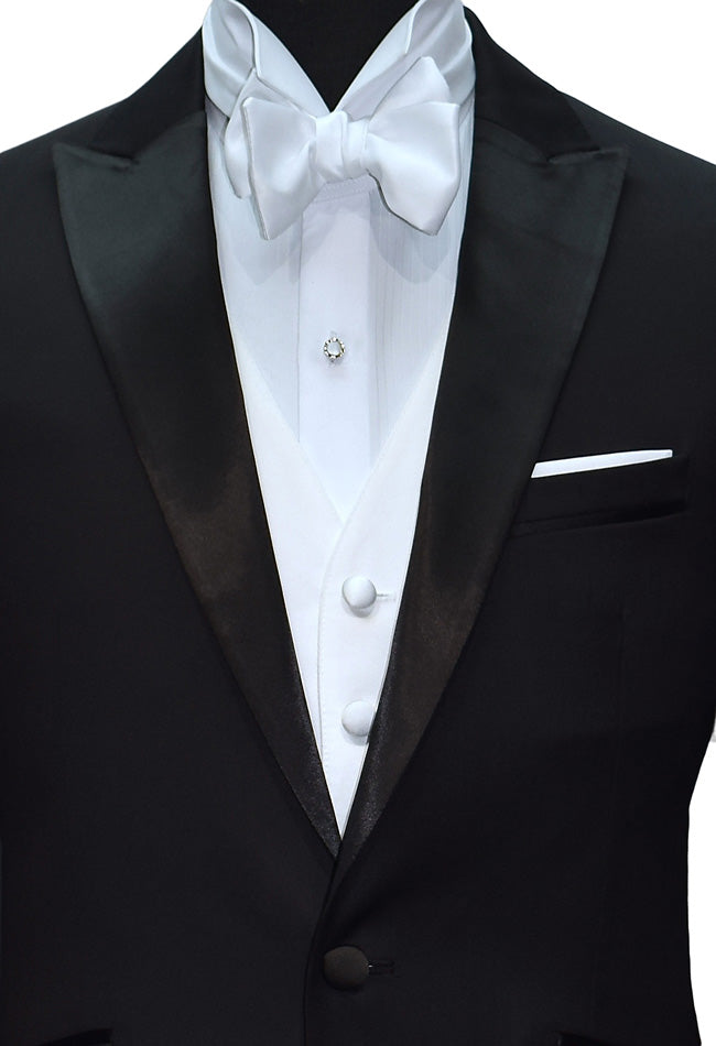 close-up black peak lapel tuxedo with a white wing collar tuxedo shirt and a white "tie-yourself" bowtie on a mannequin against a white background