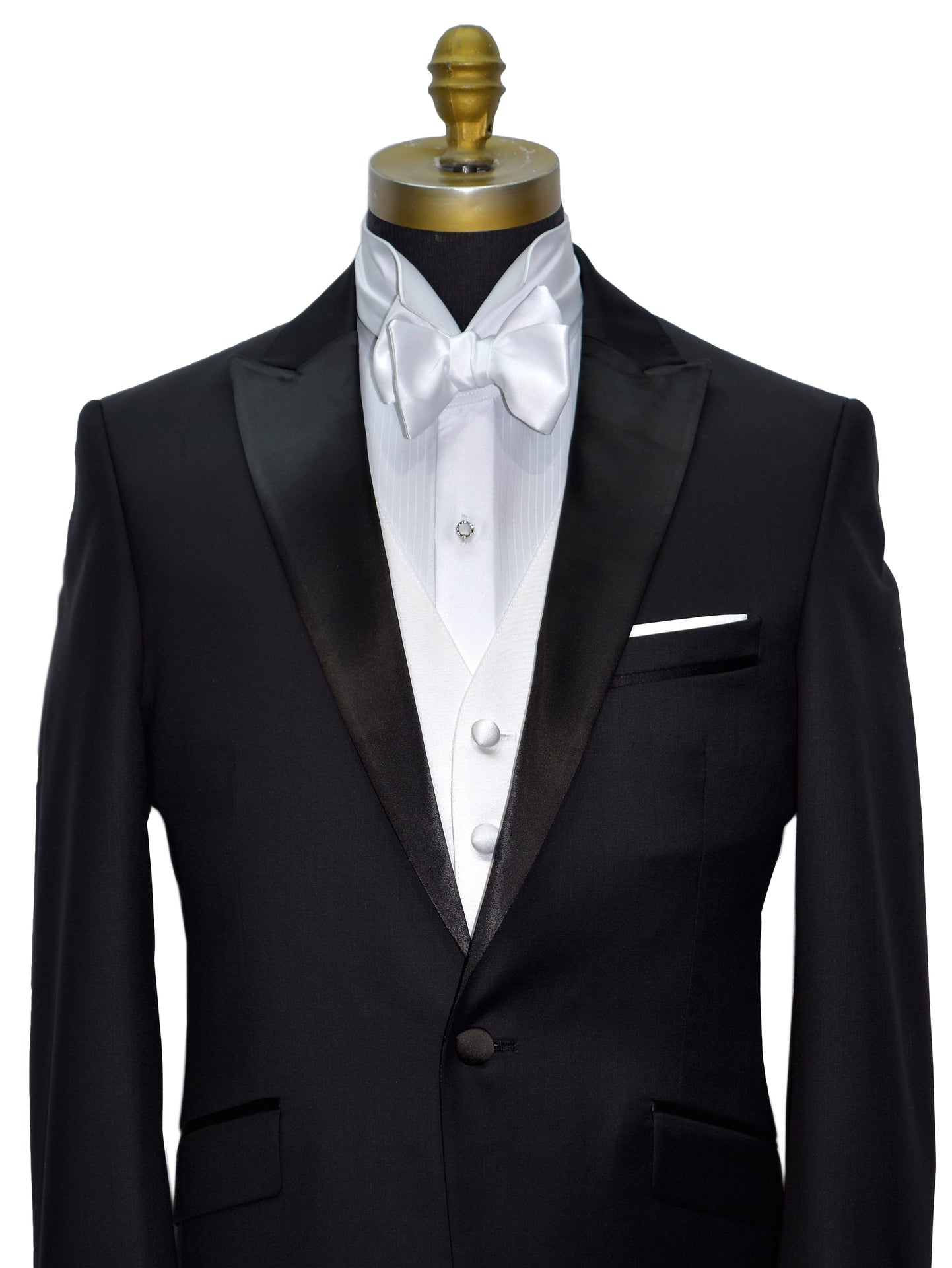 front view  black peak lapel tuxedo with a white wing collar tuxedo shirt and a white "tie-yourself" bowtie on a mannequin against a white background