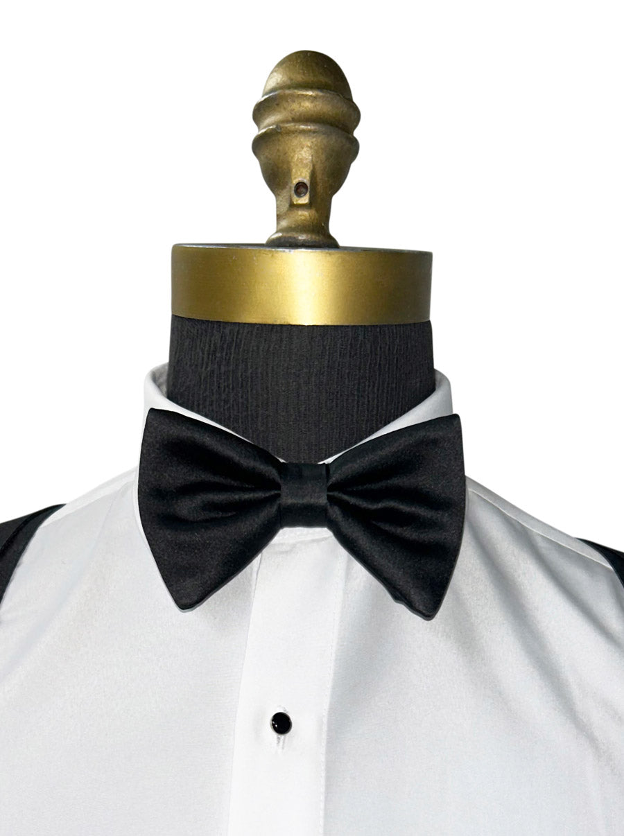 Black bow tie on a white shirt with a gold mannequin head.