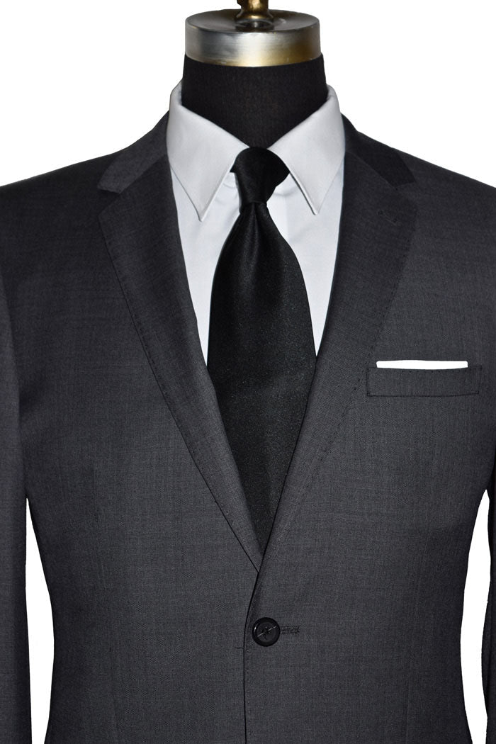 close-up Charcoal men's suit with white shirt and black silk necktie on a mannequin against a white background